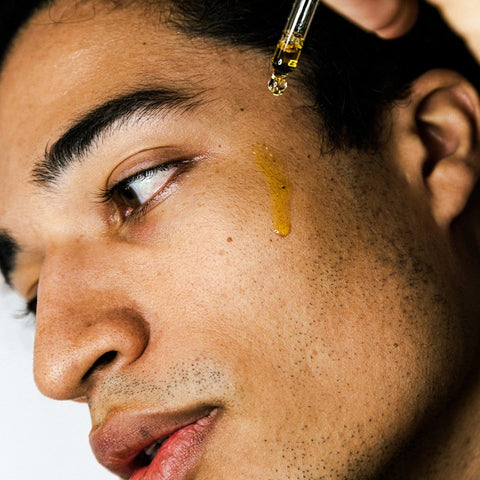 Illuminating Avocado Face Oil  being applied to a mans face