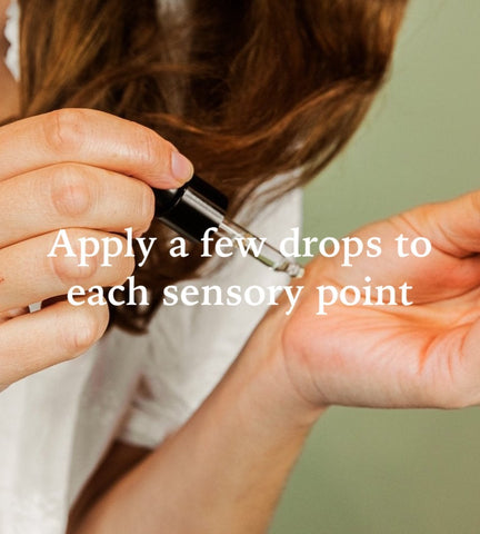A woman applying Japanese Seaweed Essential Oil to her wrist