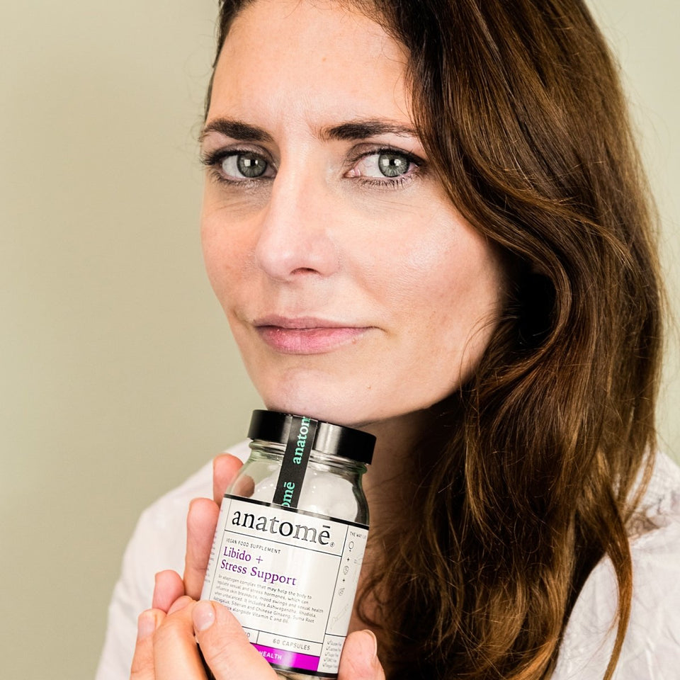 A woman posing with a stress support supplement