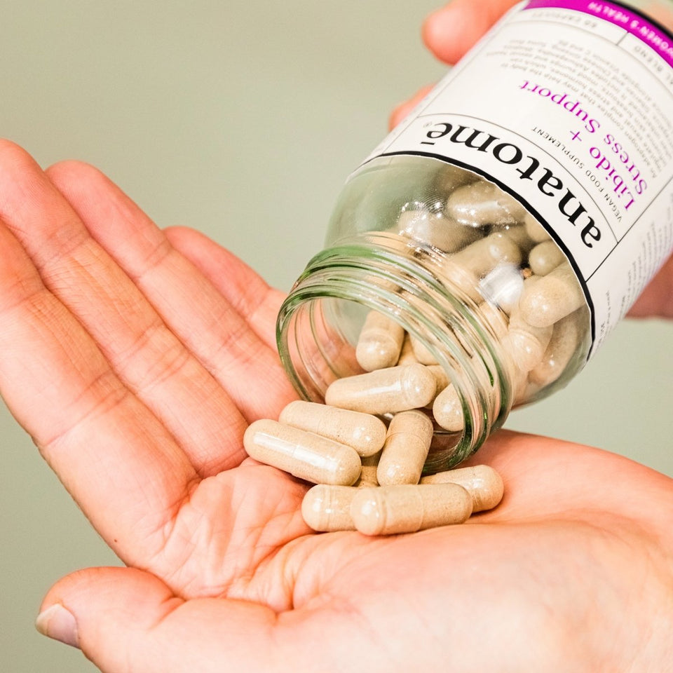 Rhodiola supplement being poured into a hand